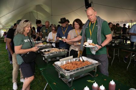 Family members getting food at a weekend meal event.