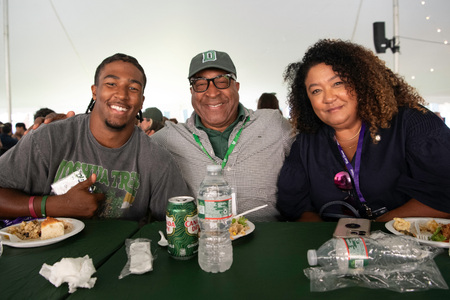 A family and student seated at a family weekend meal. 