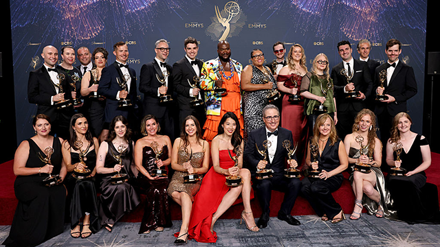 Members of the Last Week Tonight with John Oliver show posing with their statuettes at the 2025 Emmy's following their win