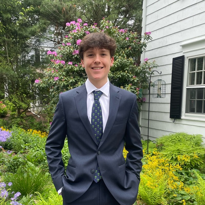 A photo of Josh posing in a suit.