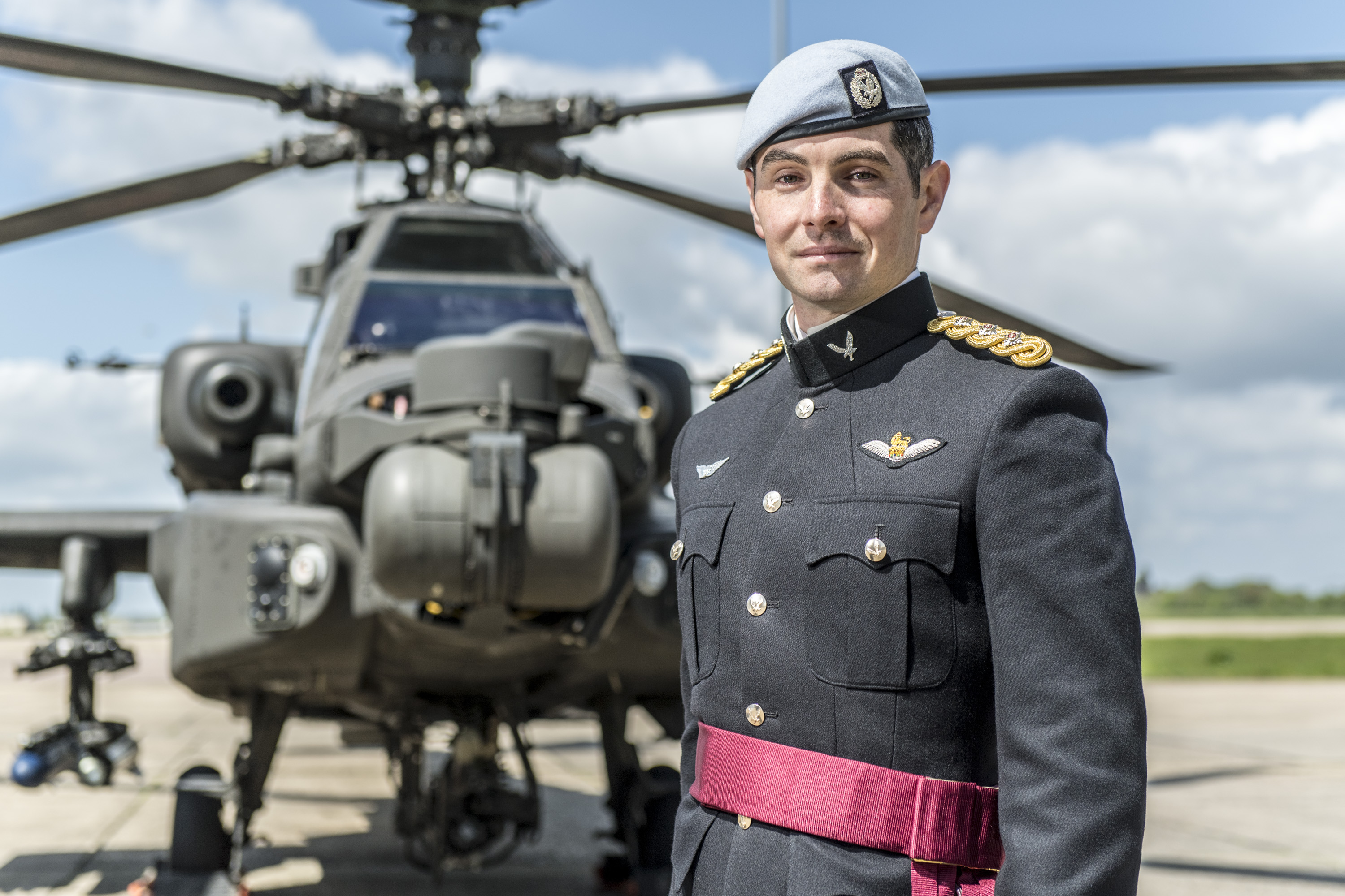 Captain William “Zack” Zehner ’09 stands in front of an Apache helicopter