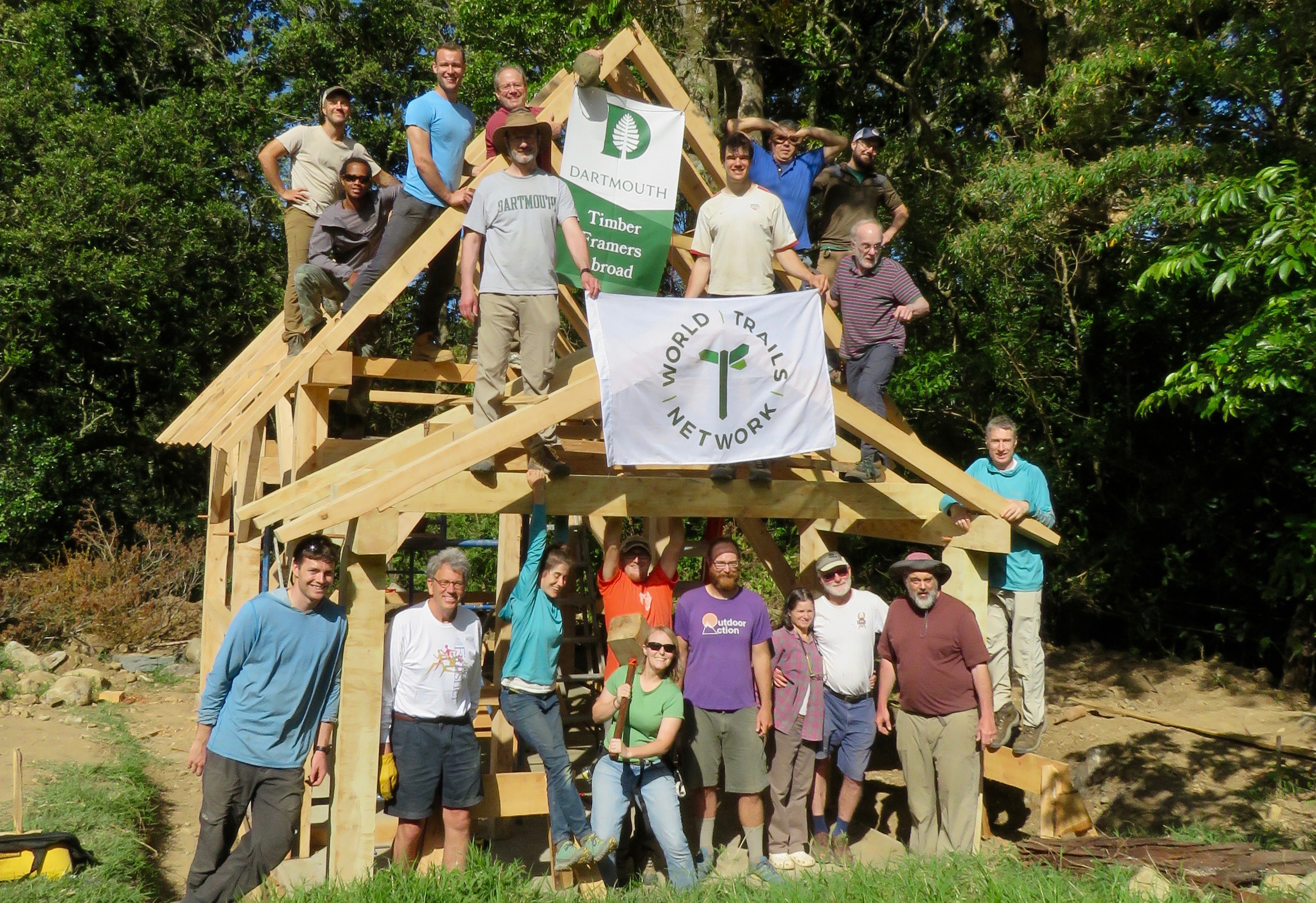 The crew poses for a photo alongside the finished timber frame.