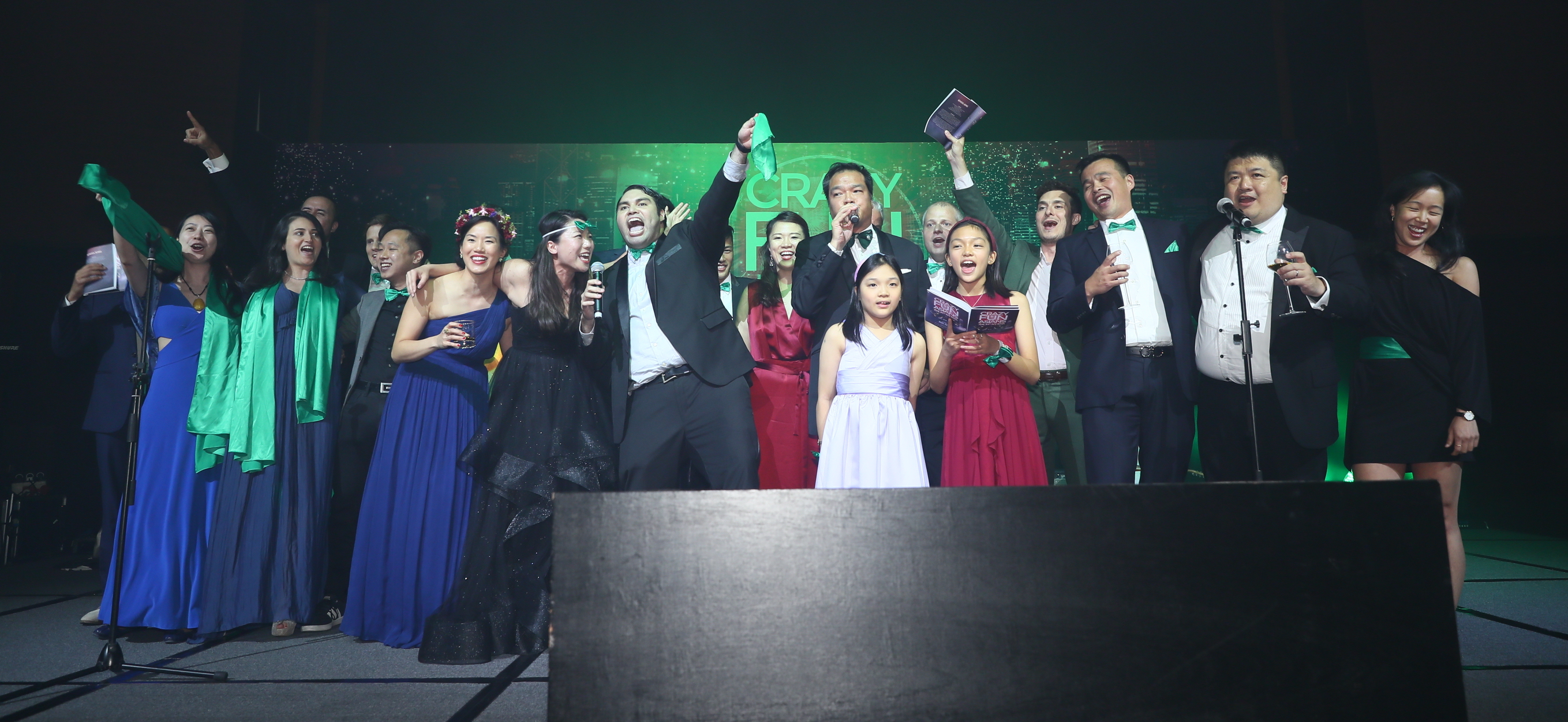 Dartmouth alumni singing on stage at the Ivy Ball in Hong Kong 