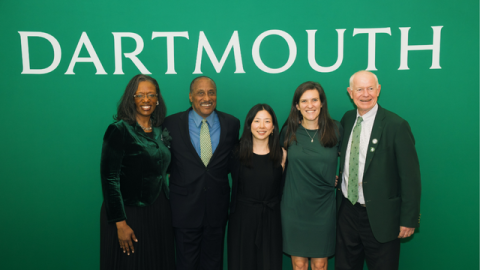 The winners of the 2024 Alumni Council awards posing in front of a green backdrop that reads Dartmouth.