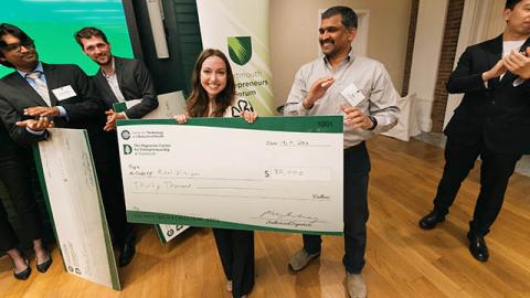 A photo of Dartmouth student Julia Hill holding a check for 30,000 in funding for RealVision