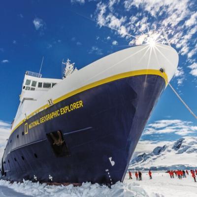 National Geographic Explorer anchored as travelers wander the ice in Antarctica